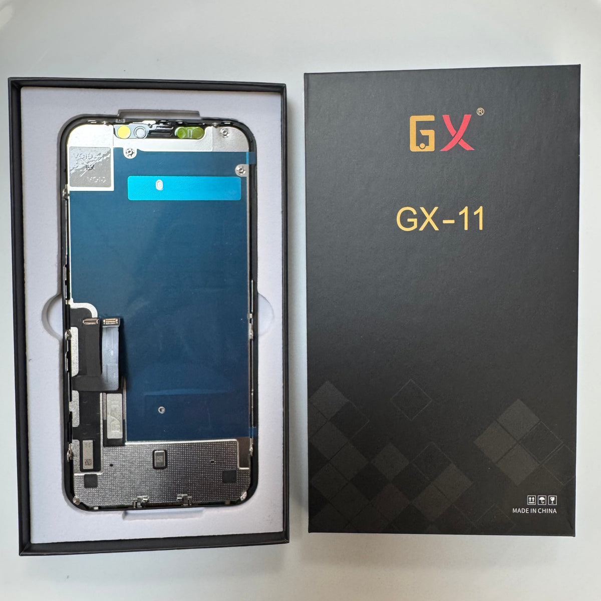 Incell HD+ LCD screen for iPhone 11 in its tray, beside its labelled box